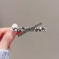 Detailed view of grey pearls and dark rhinestones on an elegant X-shaped metal hair clip - Pearl Rhinestone Cross Gunmetal #10