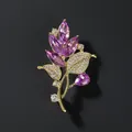 Detailed close-up of a luxury crystal orchid brooch with purple marquise petals and gold stems - Purple