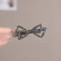 Close-up of elegant bow-shaped hair clip with dark grey rhinestones, outer diameter 6cm - Hollow Double Bow Gunmetal #9