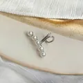 Close-up of five white pearls arranged linearly on a silver-tone U-shaped ear cuff - Silver