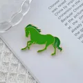 Macro shot of running pony brooch with green enamel finish and golden metal edges - Green Enamel Running Horse (Green Horse)