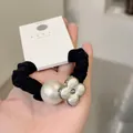 Elegant black scrunchie featuring a white faux pearl and silver clover charm - Four-leaf Flower Style