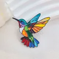 Colorful hummingbird brooch with stained glass enamel effect on a white textured background - Colorful Hummingbird Style (XZ60 Colorful Bird)