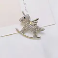Close-up of a silver unicorn brooch with sparkling white rhinestones on white fabric - Silver Rhinestone Pegasus (XZ289 Silver)
