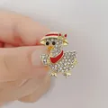 Sparkling duck brooch with white rhinestones and a red bow on golden metal base - Little Duck