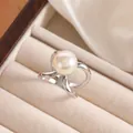 Macro shot of silver intertwined ring featuring a large creamy white pearl on satin - Silver Intertwined Line Style