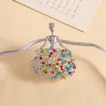 Macro shot of silver-toned angel brooch with colorful rhinestones and hollow skirt detail - Silver Angel Girl