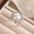 Macro shot of an elegant pearl ring with zircon accents in a premium jewelry box - Silver Hollow Vortex Style