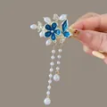 Elegant Chinese style hair clip featuring blue enamel flower and hanging pearl tassels - F1510 Blue Flower