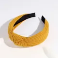 Knotted knit headband in bright yellow featuring a wide cross-stitch texture and black lining - Dark Yellow