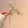 Detail of golden floral hair claw with pearl tassels and shimmering rhinestone petals - Camellia Pearl Tassel