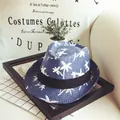 Blue kids straw fedora hat featuring white coconut tree patterns and a black ribbon band - Navy Blue