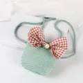 Detail of green straw mini crossbody bag with a large plaid bow and pearl accent - Light Green