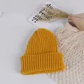 Detail of ginger yellow knit baby hat with warm ribbed texture and soft winter fabric - Earthy Yellow