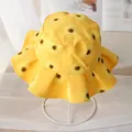 Yellow sunflower kids bucket hat with wavy ruffled brim on display stand - Yellow