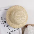 Natural straw sun hat for girls with wide brim and round top on artistic background - One Size / Beige