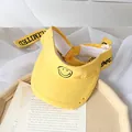 Kids bright yellow sun visor with embroidered smiley face and adjustable strap - One Size / Yellow