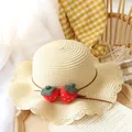 Beige woven straw sun hat for kids featuring strawberry accents and wavy brim design - One Size / Beige Straw Hat