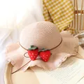 Pink straw sun hat for children featuring cute red felt strawberries and wavy brim - One Size / Pink Straw Hat