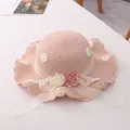 Pink woven straw sun hat for children with daisy embroidery and floral ribbon detail - Pink Straw Hat