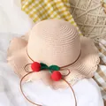 Kids handwoven straw sun hat in beige with cherry accents and wavy brim for summer - Straw Hat / Pink