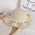 Beige scalloped edge straw hat featuring colorful pompoms and white woven trim decoration - One Size / Beige Straw Hat