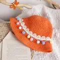 Handwoven orange straw sun hat for girls featuring daisy lace and colorful pom-poms - One Size / Orange Straw Hat