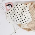 Cream polka dot baby sun hat with wide brim and chin straps for sun protection - Black Polka Dot