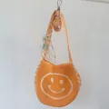 Yellow knitted smiley face shoulder bag for kids with orange geometric strap - Yellow
