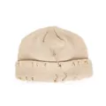 Cream knit beanie with distressed holes, silver safety pin and triple rings accent - One Size / Beige