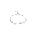 Detail of adjustable silver bracelet with six pink faceted gemstones in bezel settings - Rose Red