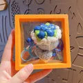 Handmade crochet blueberry cake keychain with blue bell in orange floating display box - Blue Rose (with Orange Suspension Box)