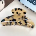 Elegant tortoise shell acetate hair claw clip with cream and brown patterns on a desk - Beige Tortoiseshell 10.5CM