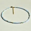Handmade summer necklace with light blue crystal beads and gold titanium steel accents - Light Blue