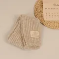 Thick knitted winter scarf in oatmeal beige with a minimalist woven label patch - Beige