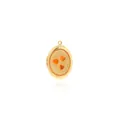Macro detail of golden oval photo locket with orange heart motifs and wavy texture - Orange