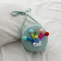 Bolso bandolera tejido verde menta para niñas con ojos de dibujos y pompones de colores - Verde Lago