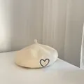 Classic beige wool beret for kids featuring a delicate black embroidered heart - One Size / Beige