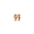 Detailed macro of gold hoop earrings with red enamel evil eye charms and clear zircons - Red