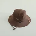 Kids wide brim outdoor bucket hat in dark brown featuring Lucky embroidery and chin strap - Brown