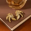 Minimalist gold flame leaf earrings with high-polish mirror finish in a lifestyle setting - Golden Streamlined Leaf Flame Earrings (S2376-1)
