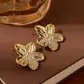 Elegant gold five-petal flower earrings with a polished finish on vintage book background - Golden 3D Five-Petal Flower Earrings (S2380-1)