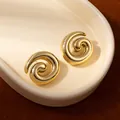 Minimalist spiral floral earrings in polished gold finish displayed on a ceramic tray - Golden Swirl Spiral Rotating Earrings (S2511-3)