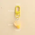 Resin ice cream cone keychain with bright yellow hook and colorful sprinkles detail - Clear