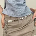 Bohemian silver metal star waist chain with Y2K style fringe hanging over a skirt - Five-pointed Star Tassel Style (K0237)