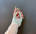 Handheld view of a sweet beaded charm with mint green bow and clover details - Bow Beaded Charm (B-246) / Mint Green
