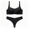 Flat lay of seamless black bra and thong set with high-stretch smooth fabric - S / Black