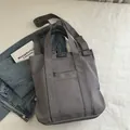 Versatile grey canvas tote bag with adjustable shoulder strap and fashion instinct logo - Gray