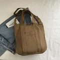 Dark brown canvas tote bag with front zipper pocket and adjustable shoulder strap - Brown