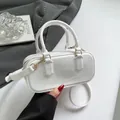 Minimalist white glossy cylinder handbag with gold hardware and detachable strap - White